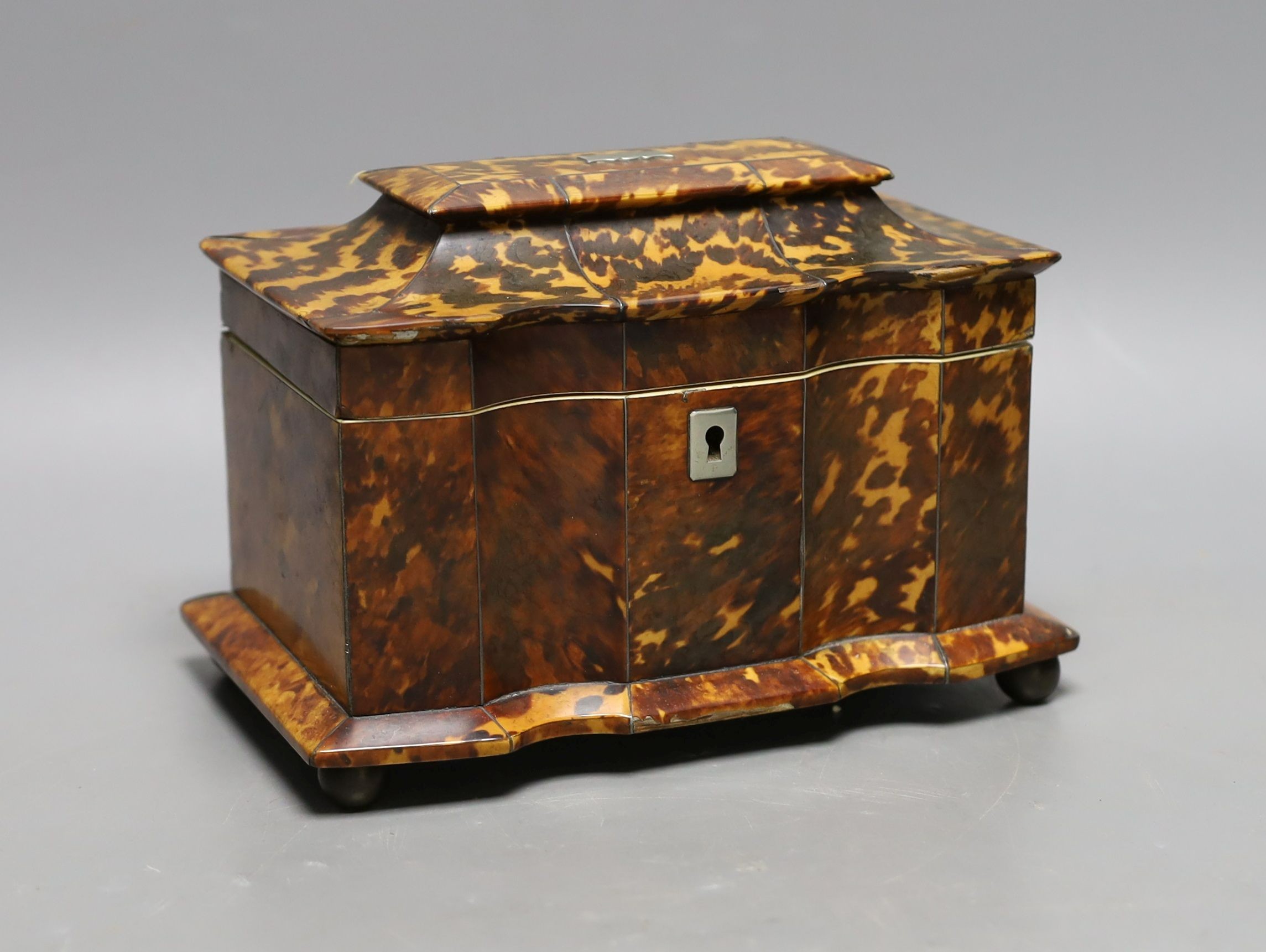 A 19th century tortoiseshell veneered tea caddy, ivory veneered edging, 20cms wide